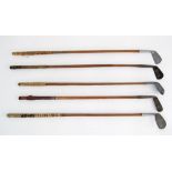 Hickory shafted steel golf clubs.