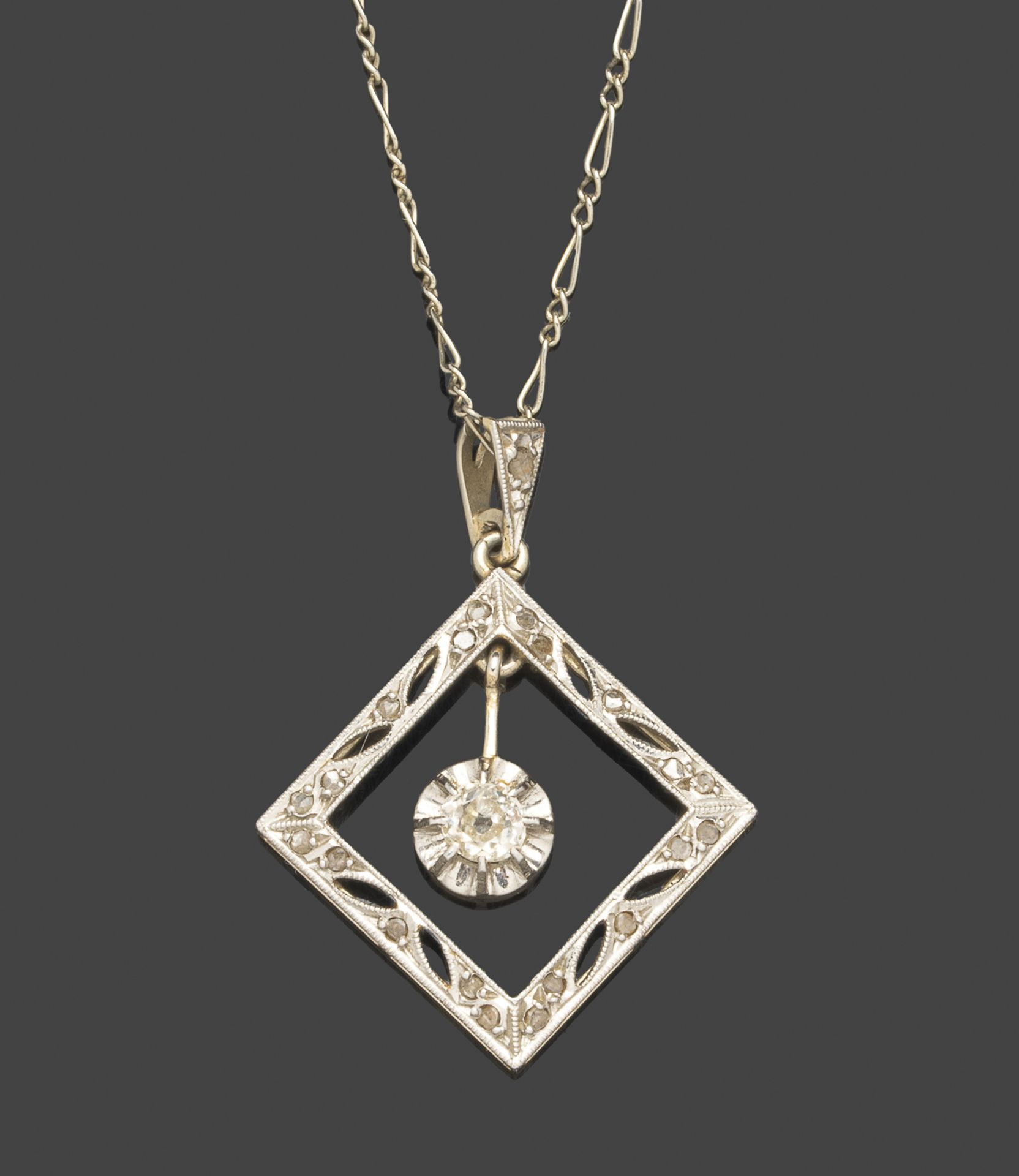 Pendentif en or blanc, de forme losangique centré d’un diamant mobile. (petit choc).Avec sa chaine
