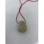 A Reticulated Chinese jade bottle with red cord Pendant/ Necklace