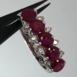 18k white gold ring with 5 rubies and white diamonds and sapphires