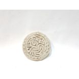 AN ISLAMIC TERRACOTTA STAMP WITH ENGRAVINGS