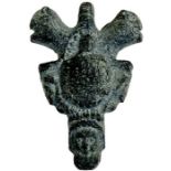 Gray schist stone magical amulet in a form of an pendant with head of a man and mythical animals