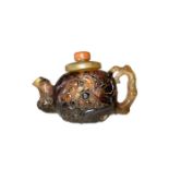 CHINESE AMBER TEAPOTIN FORM OF POMERGRANATE WITH CORAL TOP HEAVILY EMBOSSED QING PERIOD