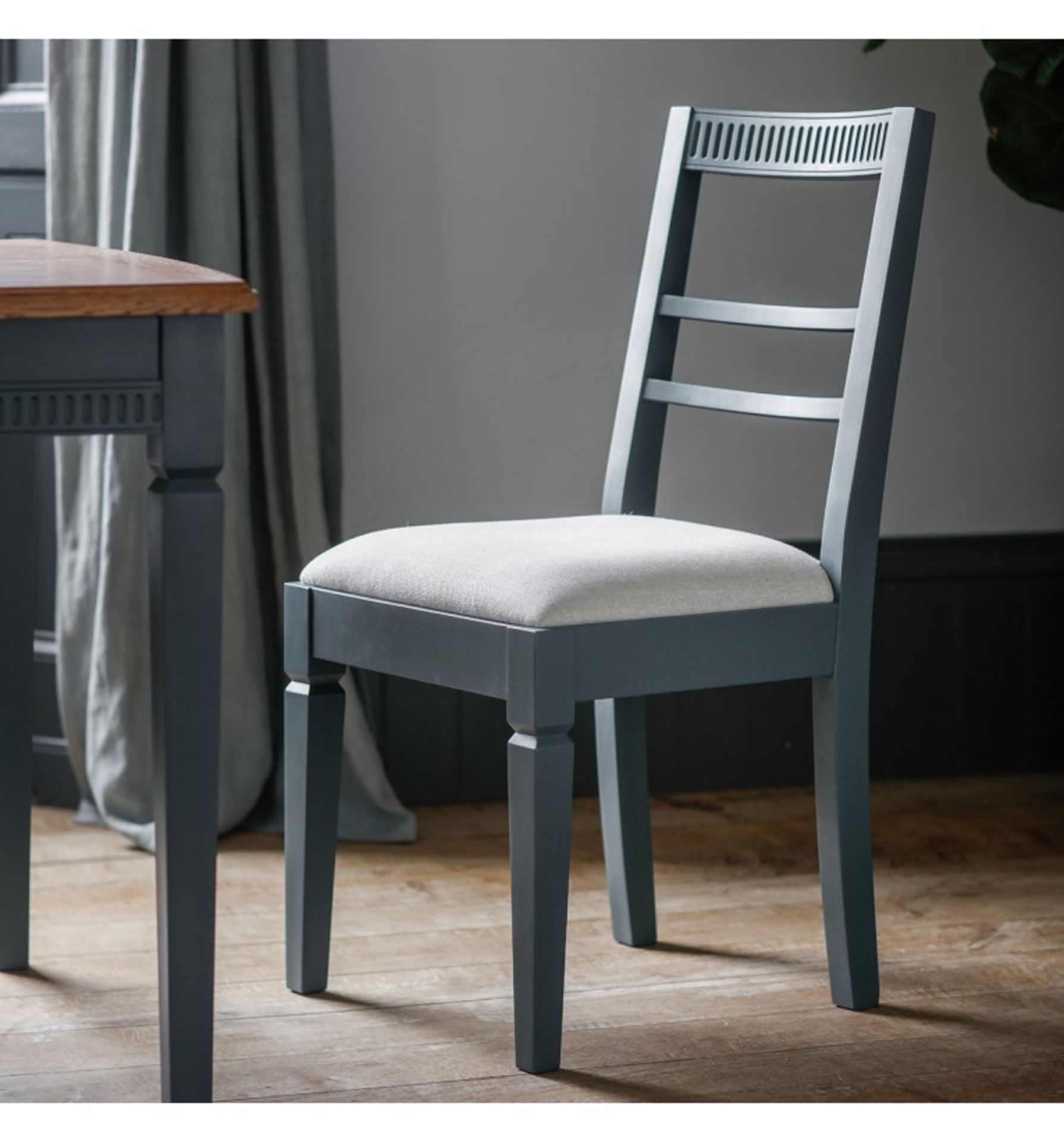 A Pair Bronte Dining Chair in Storm is made using painted mahogany solids with an upholstered