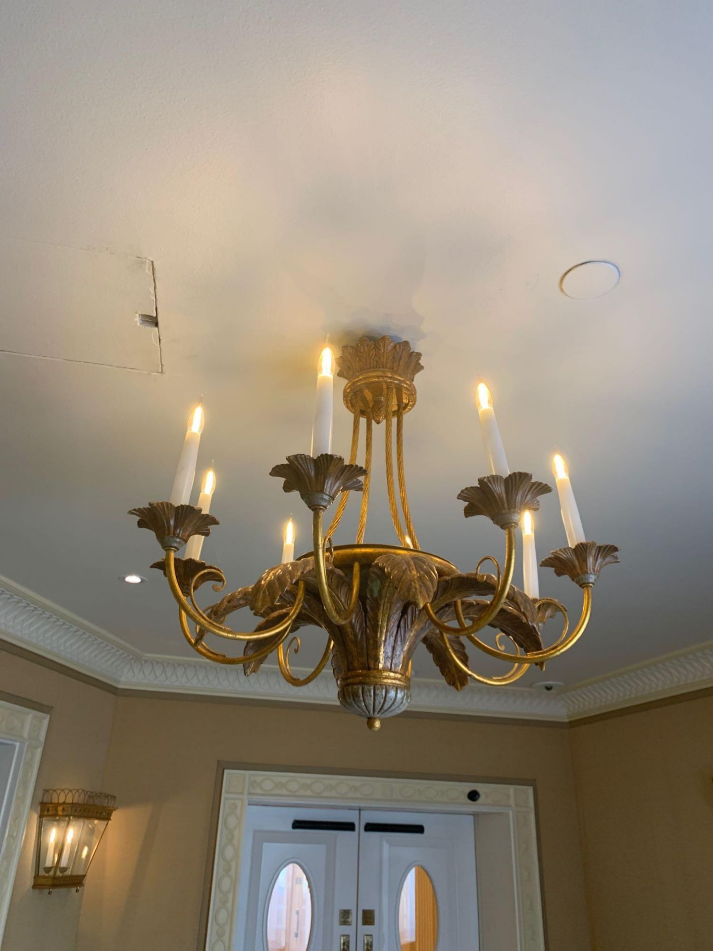 A Carved Polychrome Eight Lamp Chandelier Finished In Antique Bronze Colour Carved Scrolls And