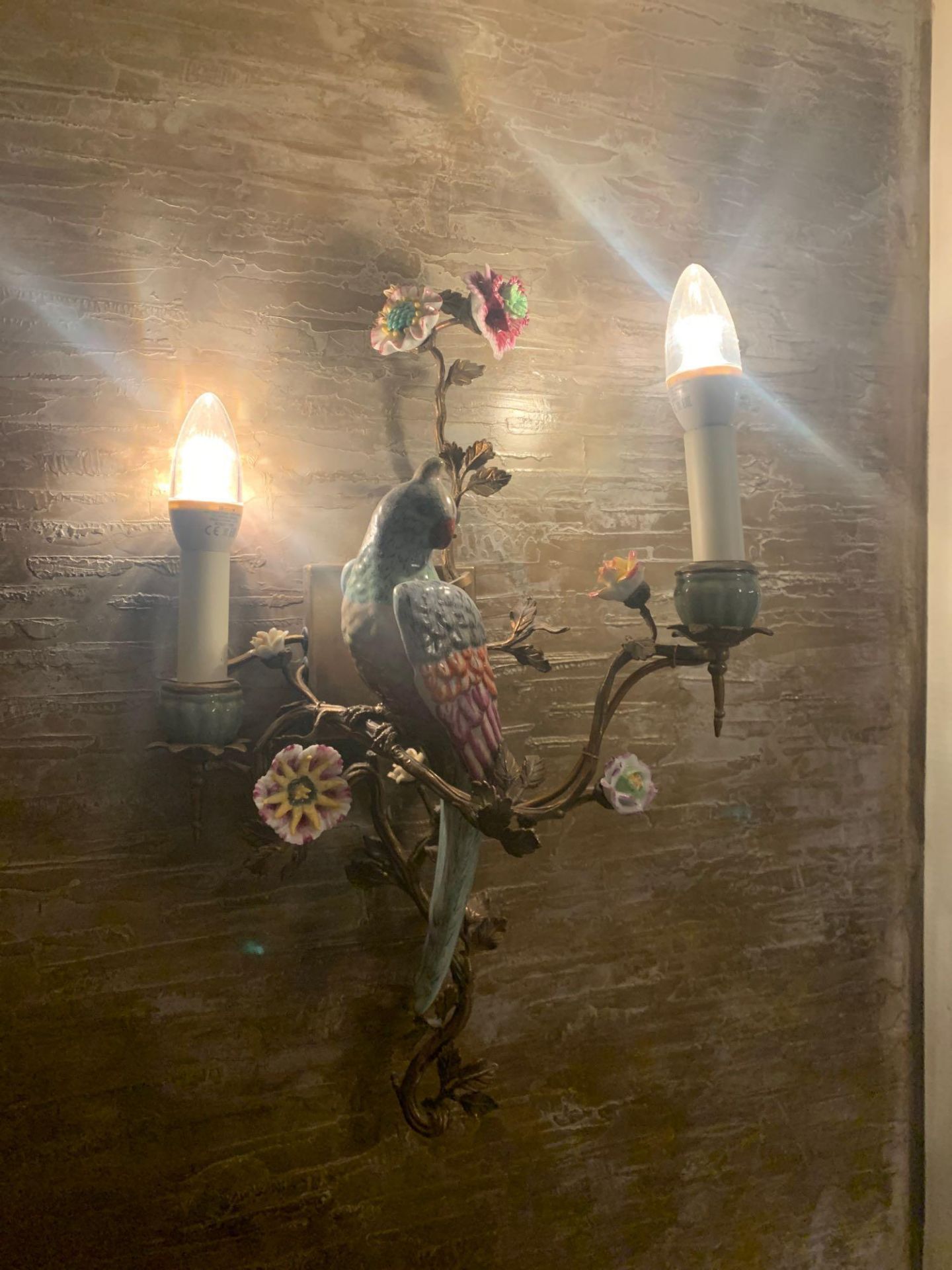 A Pair Of French Gilt Metal And Porcelain Twin Light Parrot Wall Appliques Featuring Delicate