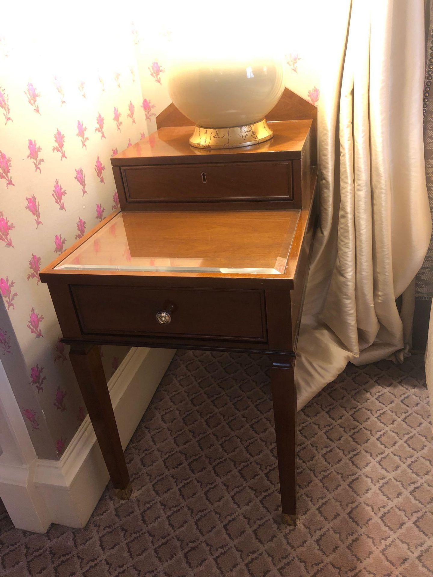 A Pair Of Two Tier Bedside Nightstands With Storage Compartments Mounted On Tapered Legs With
