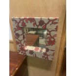 A pair of small woven read framed accent mirrors