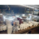 A large quantity of various crockery comprising plates, bowls, cups, suacers, cruet sets etc