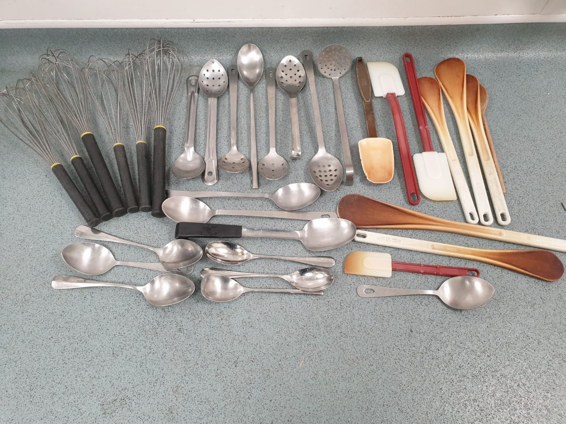 A large various quantiity of kitchen utensils whisks, spoons, spatulas etc