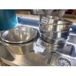 A quantity of large stainless steel bowls as lotted