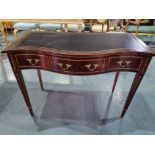 A serpentine mahogany and floral marquetry writing table with black leather inlay Height 78cm