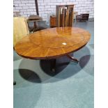 Arthur Brett circular extending mahogany dining table on single pedestal with five legs on brass