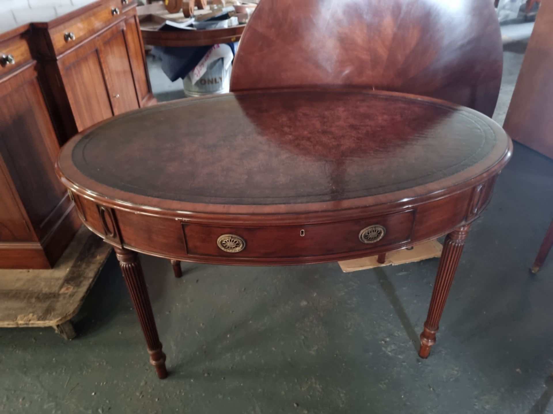 Arthur Brett Regency-style Mahogany Oval Writing Table In Antique Finish Mounted on turned and