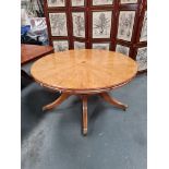 Arthur Brett Extending Circular Dining Table With Olivewood Veneers on one pedestal with five legs