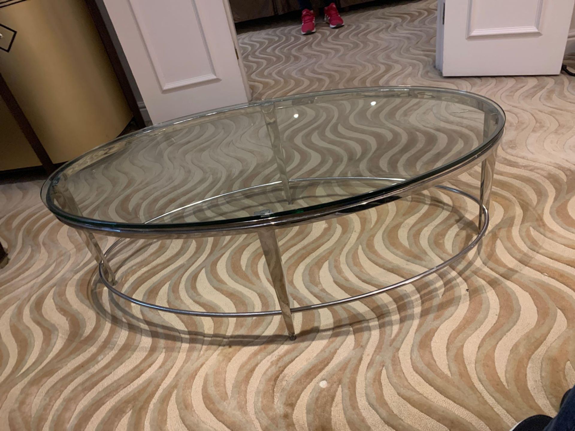 A polsihed Nickel Oval Coffee Table Glass Top 120 X 61 X 41cm