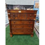 A Victorian mahogany chest. The oblong top above a flush frieze and a panelled hat drawer flanked by