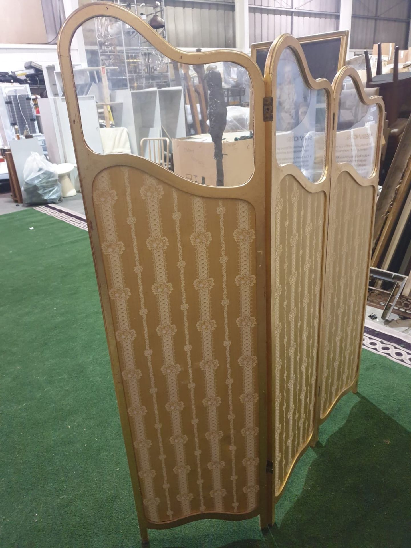 A giltwood and upholstered screen.The three graduated panels with glazed upper panels over damask- - Bild 2 aus 3