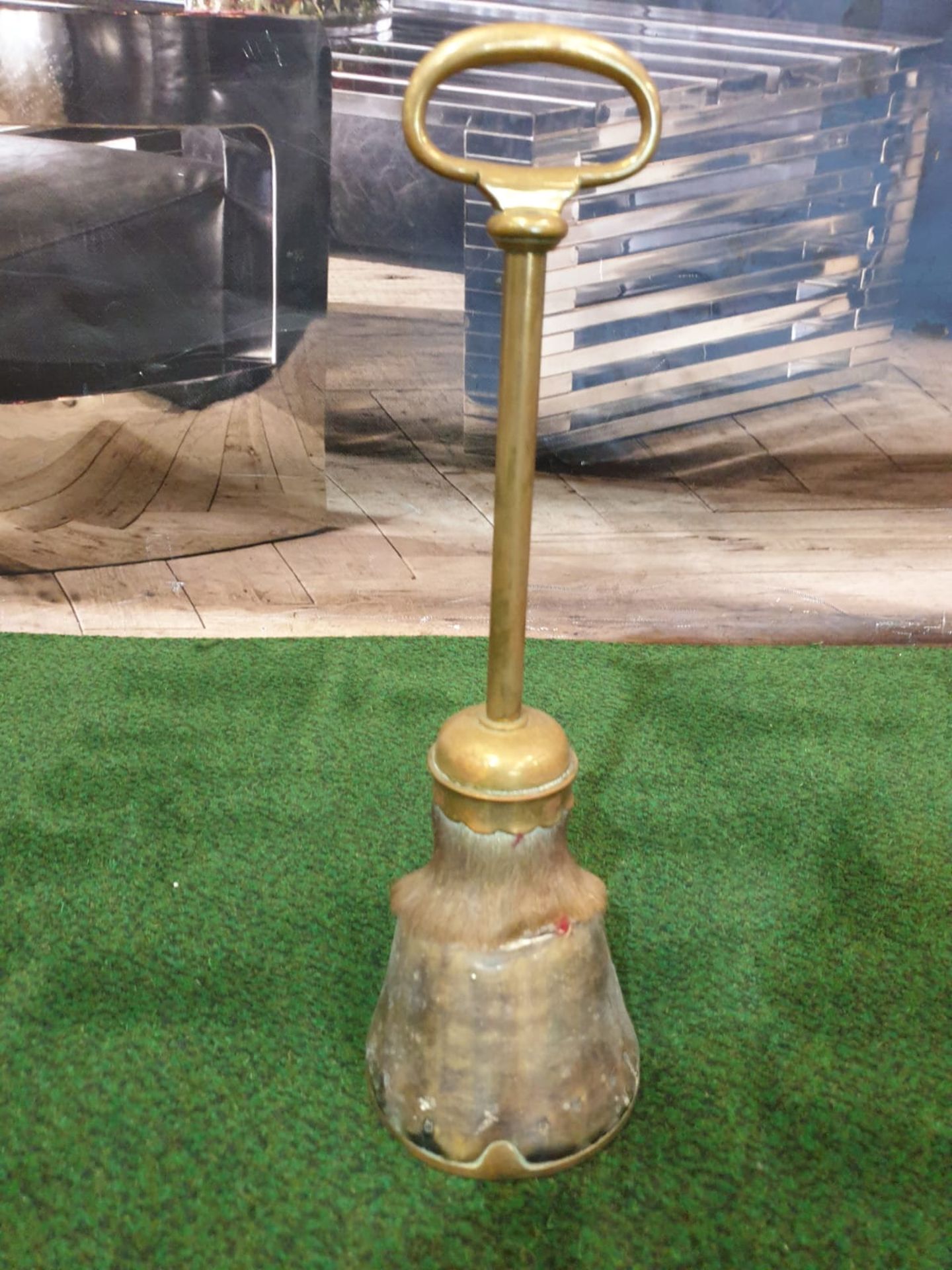 A Victorian brass mounted horse's hoof door stop.The hoof mounted with brass with a ring handle