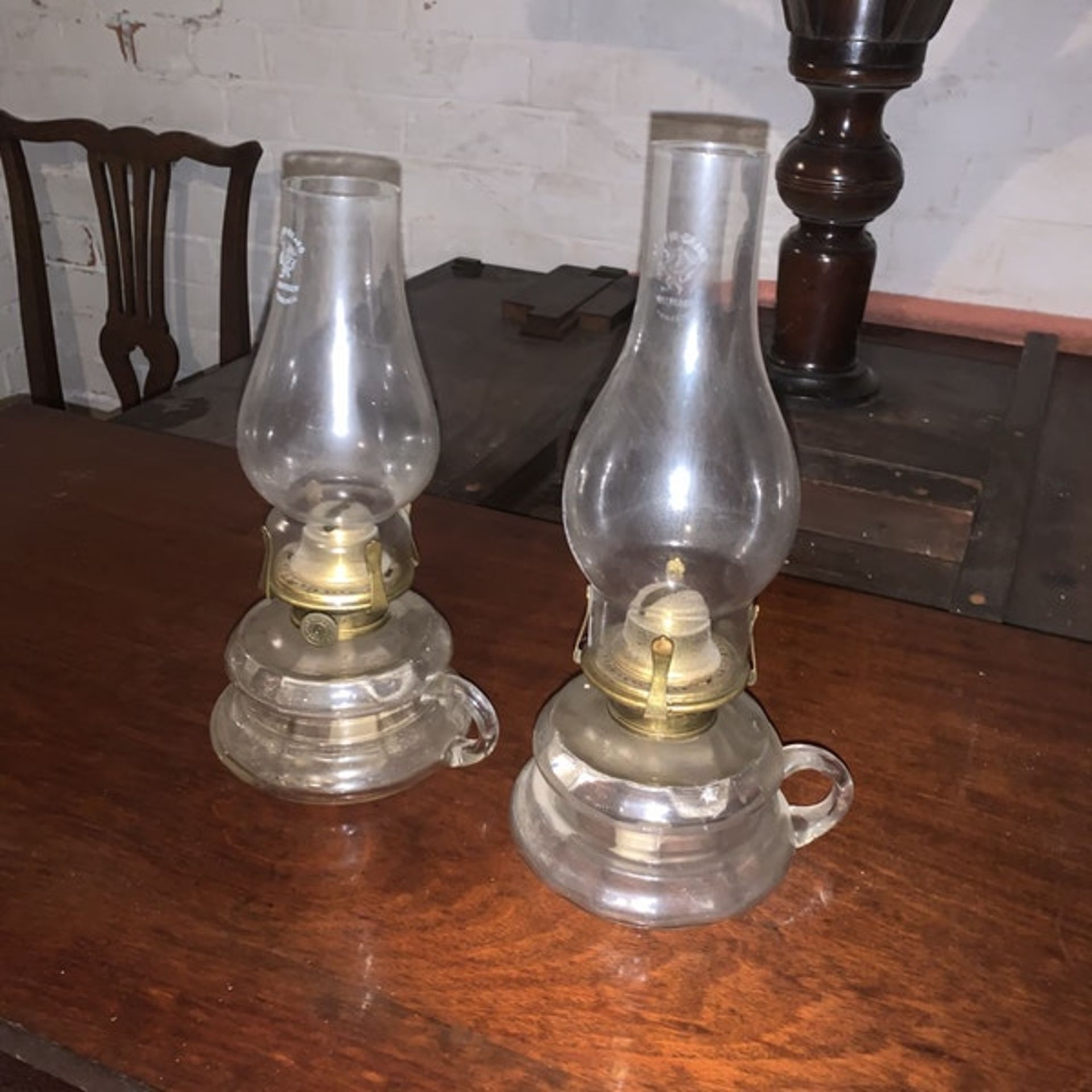 A pair of Griffin Brand glass oil lamps with carrying handles c. Circa 1920 Height 26 cm; Length