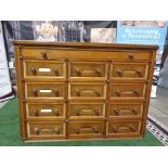 A Victorian oak office chest of drawers. With rounded corners and panelled sides, the top long
