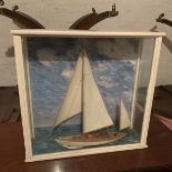 A scratch built model of a sailing yacht in a glass and painted wooden case. A scratch built model