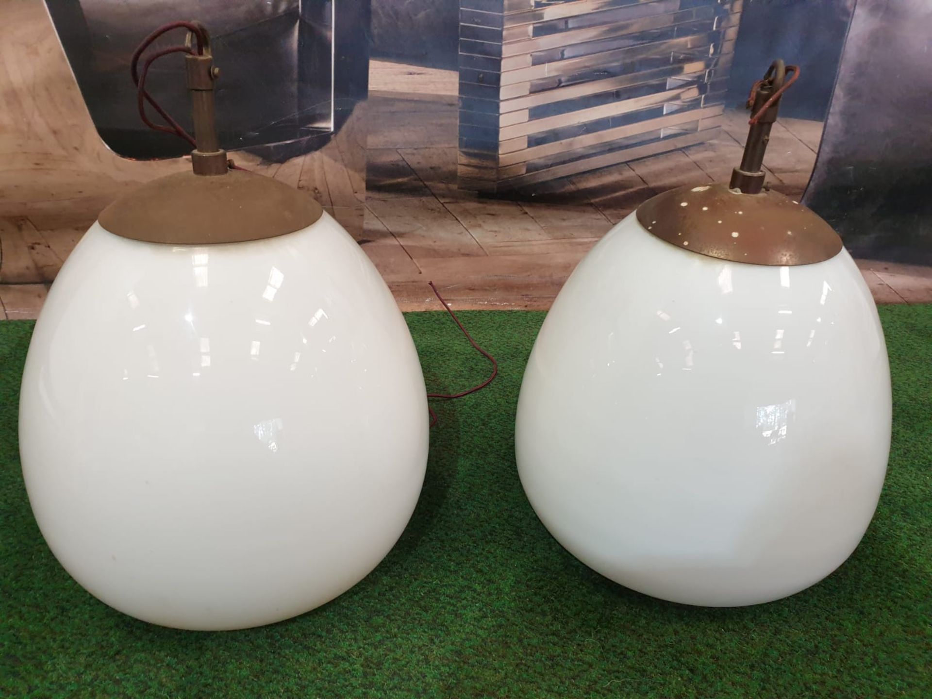 A pair of white glass and metal mounted pendant lights.Of ovoid form and with copper caps and - Image 3 of 3