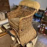 A wicker childs horse saddle formed as an armchair with straps and stirrups. c. Circa 1910 Height 60