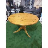 Round Dining Table in Repurposed Pine with Antique Pine Pedestal The table's pedestal, which is