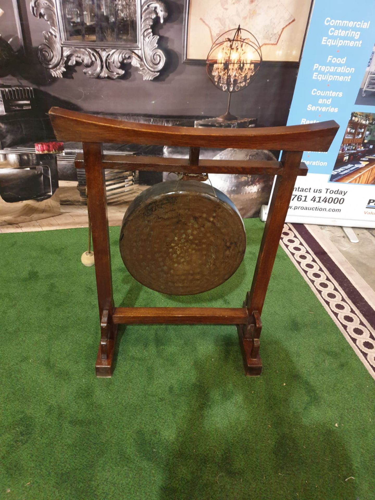 An Oriental brass gong on wooden stand An oriental, possibly Chinese circular hammered brass gong on