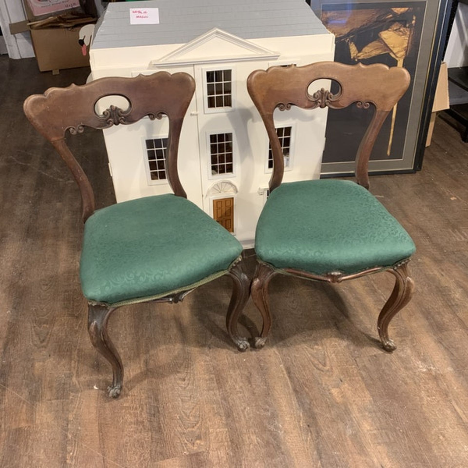 A pair of Victorian walnut chairs. The spoon shaped backs with moulded supports and a shaped and