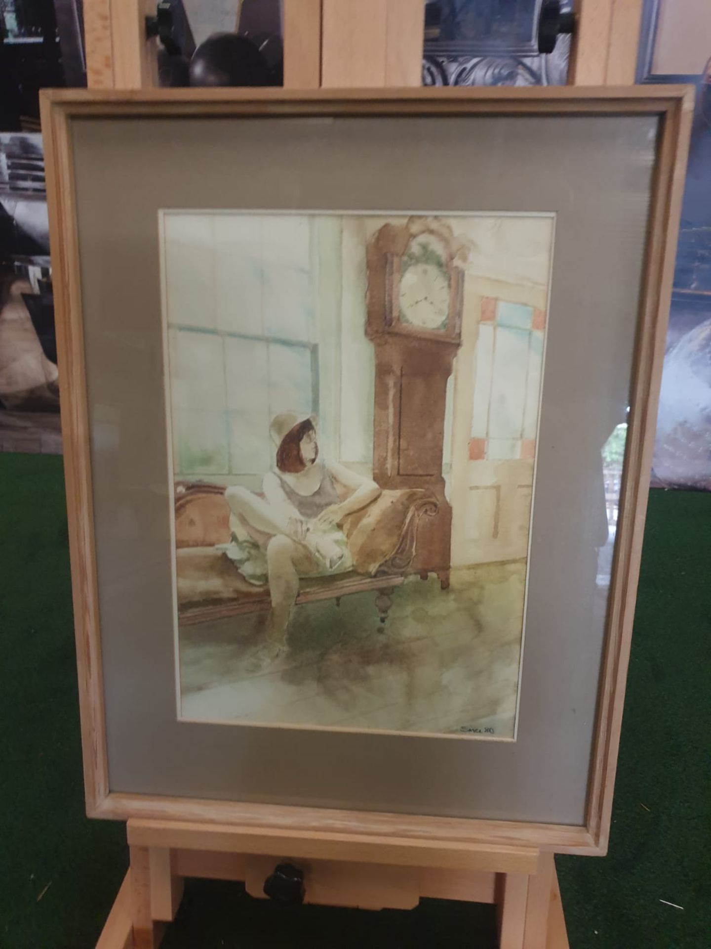 Framed watercolour Woman on chair by Grandfather clock singed and dated by Michael Smee '80