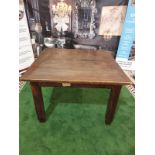 An English stained oak dining table. The square top on square chamfered legs with tapered feet. c.