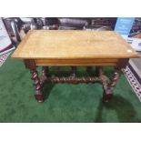 A Spanish 17th century style walnut side table. The faded cleated twin plank top above a drawer,