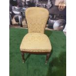A pair of George III mahogany and upholstered side chairs Each with a rounded shaped padded back and