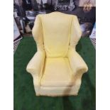 A 1940s style upholstered wing back armchair An elegant and unusual wing chair with curvaceous