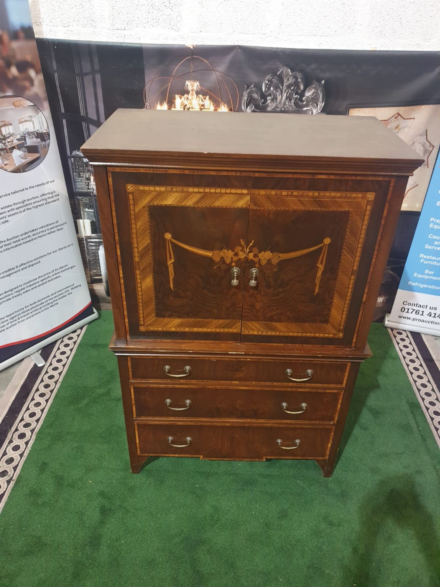 A Georgian style reproduction TV cabinet with three drawers under in mahogany veneers with a classic