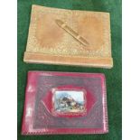 A vintage red leather with picture inset photo album and a tan light brown leather writing pad