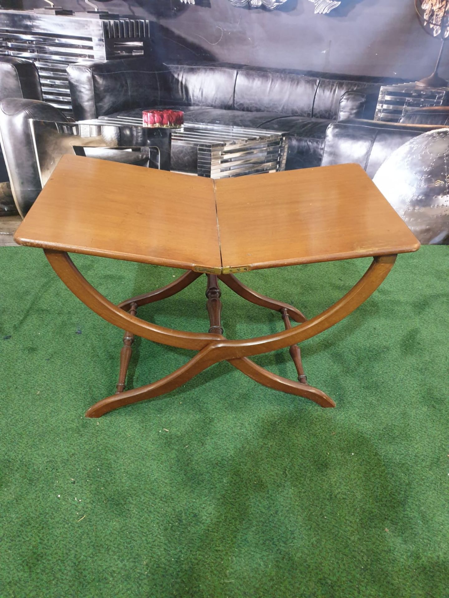 A polished mahogany folding table 76 x 43 x 49cm (Nb bar latch missing)