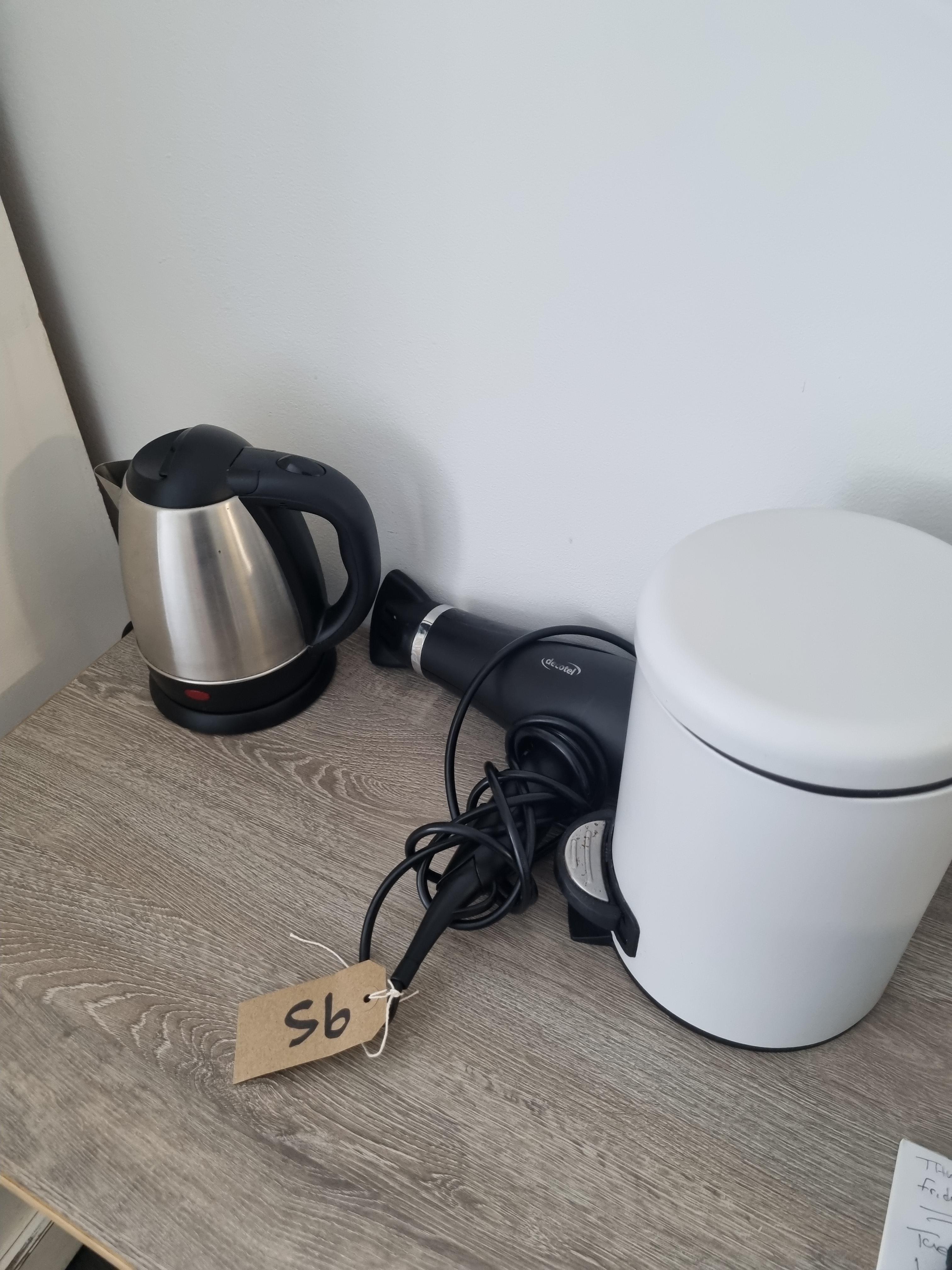 A Room Set Comprising Of White Pedal Bin Hairdryer and Kettle