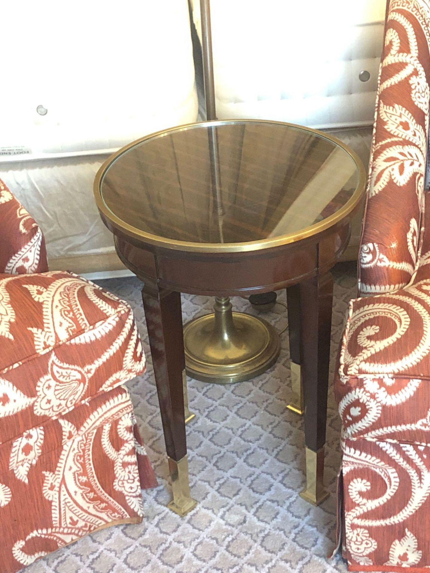 Circular Side Table With Antiqued Plate Top And Brass Trim Mounted On Tapering Legs With Brass