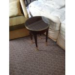 Circular Side Table With Antiqued Plate Top And Brass Trim Mounted On Tapering Legs With Brass