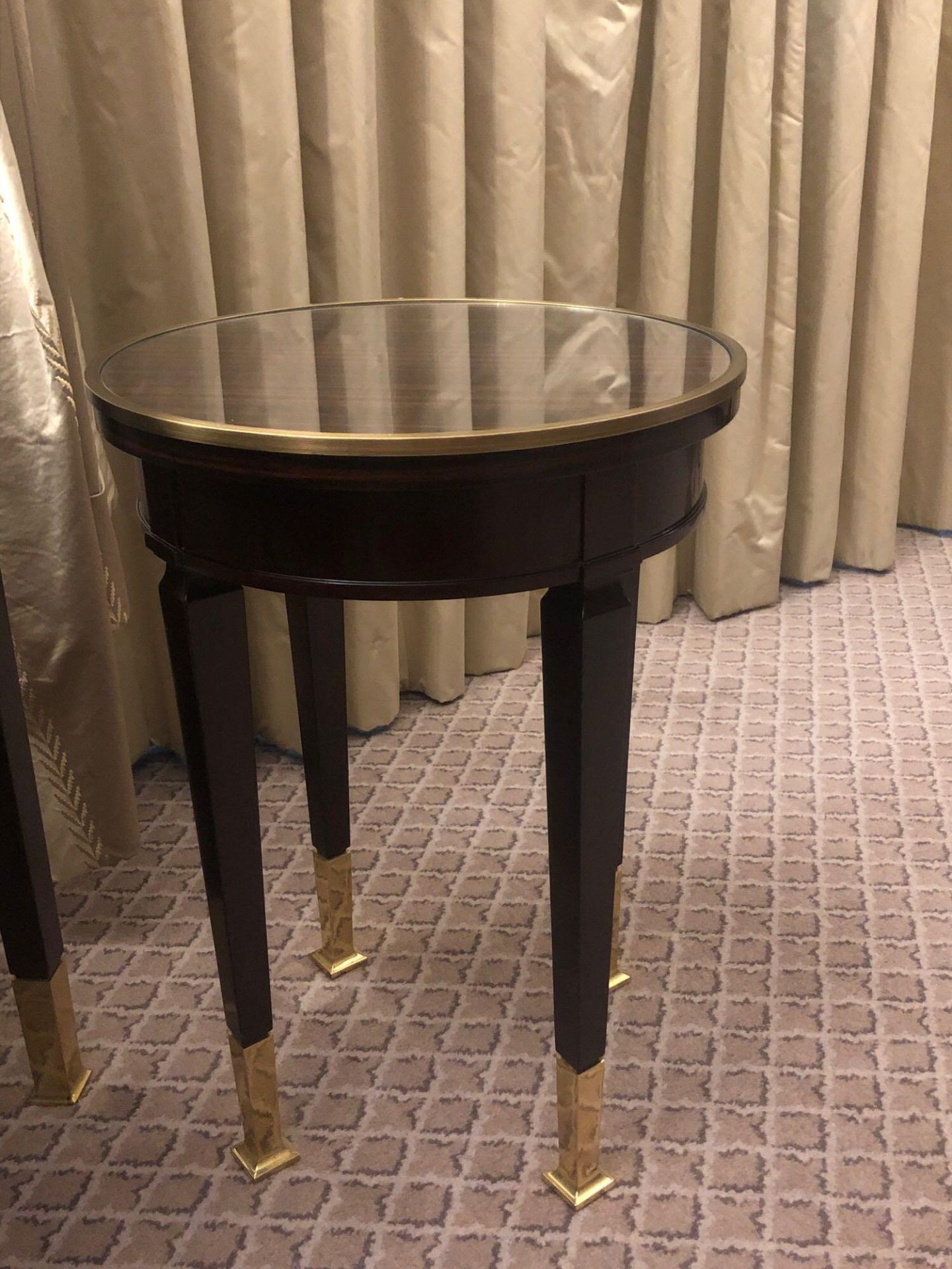 Circular Side Table With Antiqued Plate Top And Brass Trim Mounted On Tapering Legs With Brass