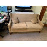 A contemporary two seater upholstered sofa wooden framed with beige brown upholstery repeating