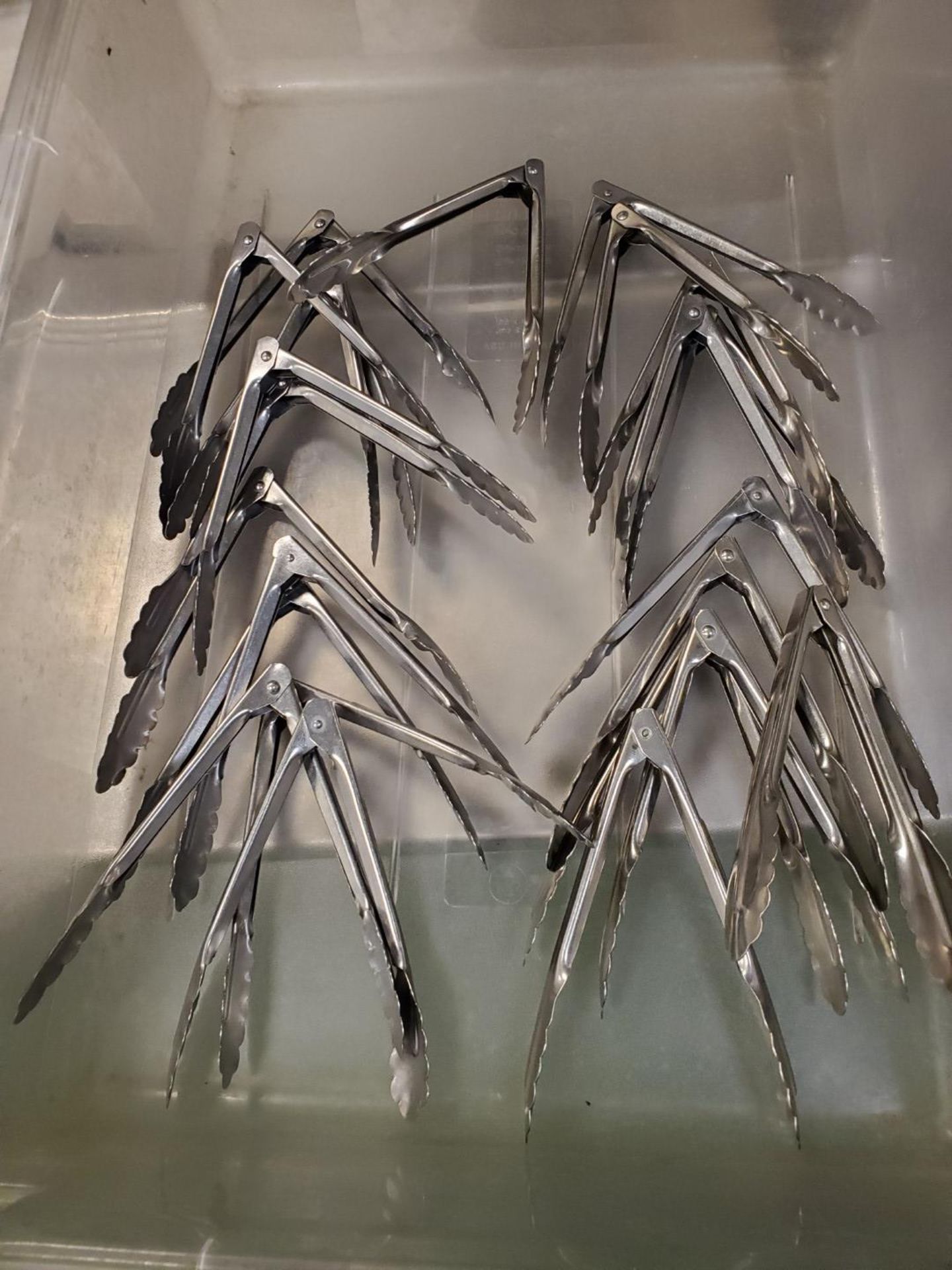 Lot of small serving tongs.