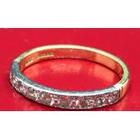 A DIAMOND HALF ETERNITY RING SET WITH 9 STONES IN 18ct GOLD