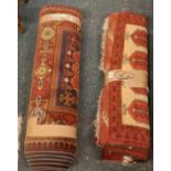 2 PATTERNED RED RUGS - 1 BEING 3ft 6'' X 2ft 6'' & THE OTHER 9ft X 2ft 6''