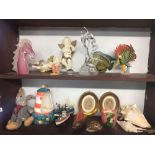 2 SHELVES OF NOVELTY ITEMS INCL; CHERUBS, MODEL BOATS, GLASS HORSES HEAD, FIGURE, SHELLS & OVAL