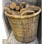 LARGE WICKER BASKET FULL OF WOODEN LOGS