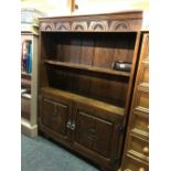 OAK CARVED BOOKCASE WITH 2 DOOR CUPBOARD